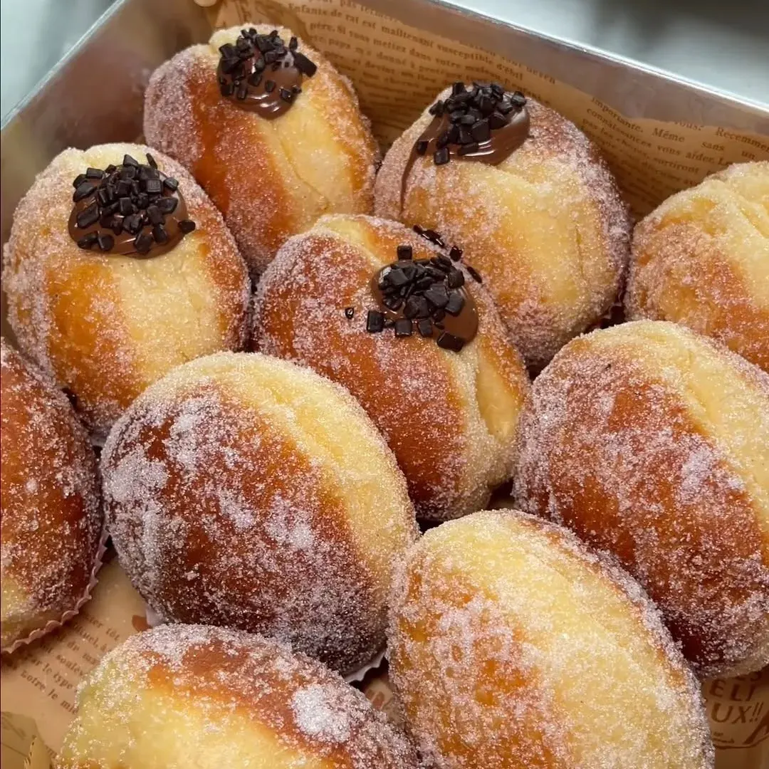 Sugar-dusted donuts filled with chocolate