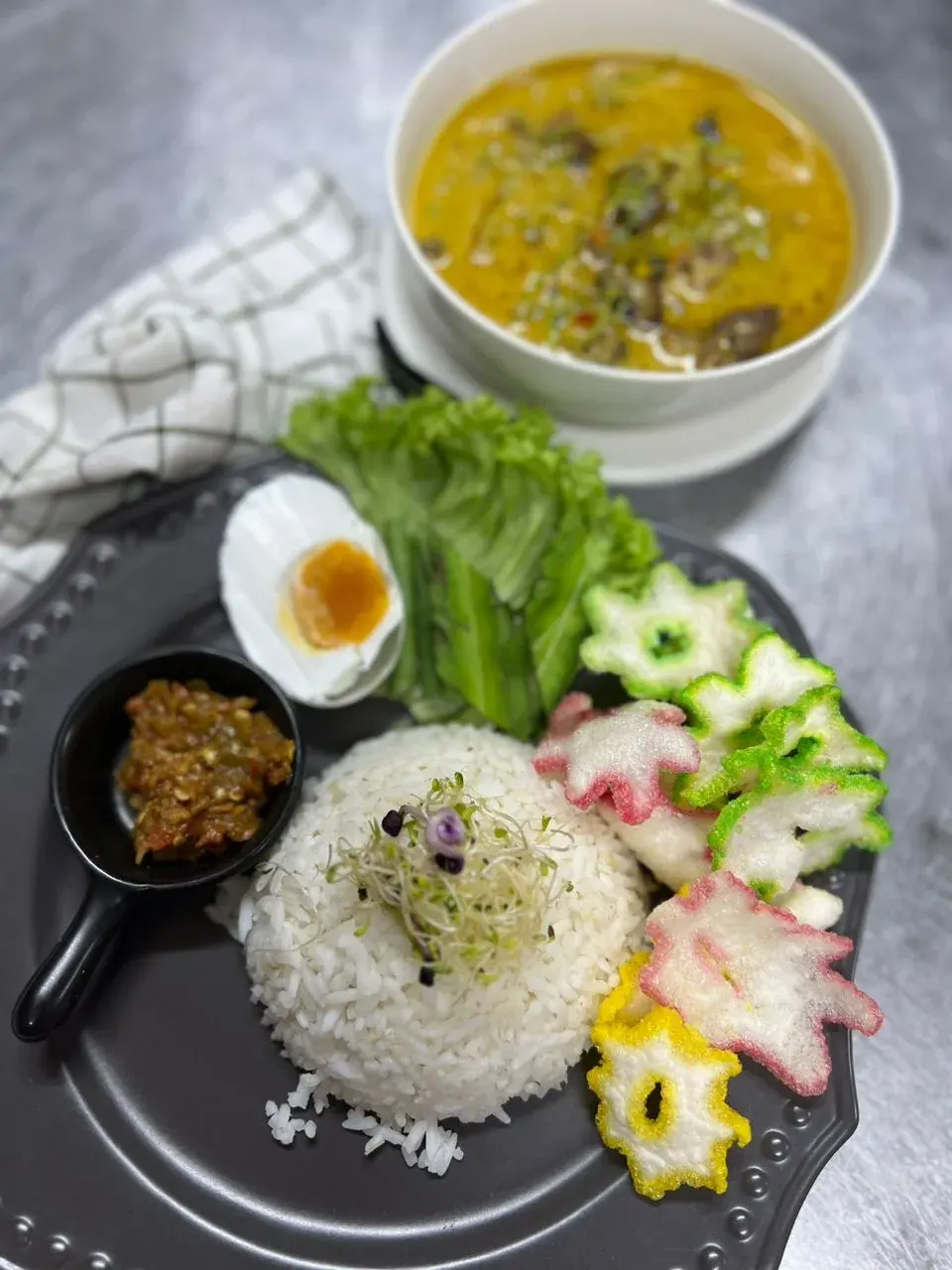 Rice plate with curry, salted egg, ulam and sambal