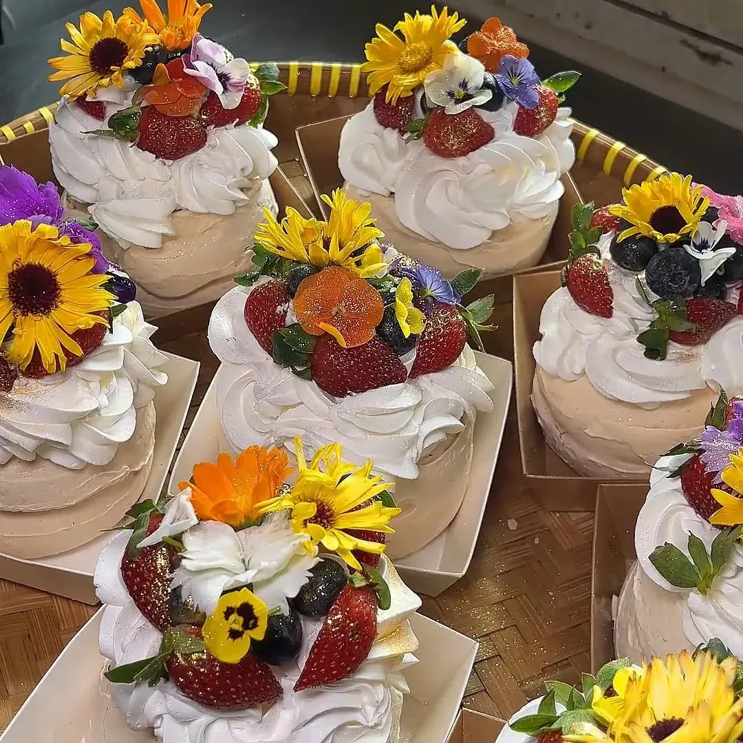Mini pavlovas with fresh berries and edible flowers