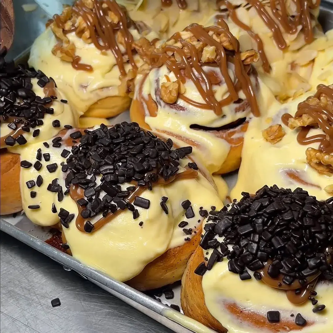 Freshly baked cinnamon rolls with chocolate and caramel toppings
