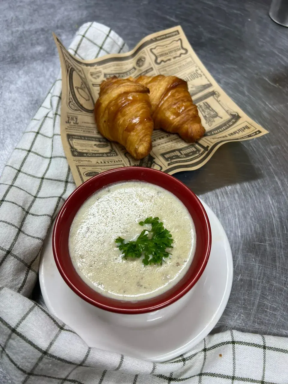 Mushroom soup served with croissants