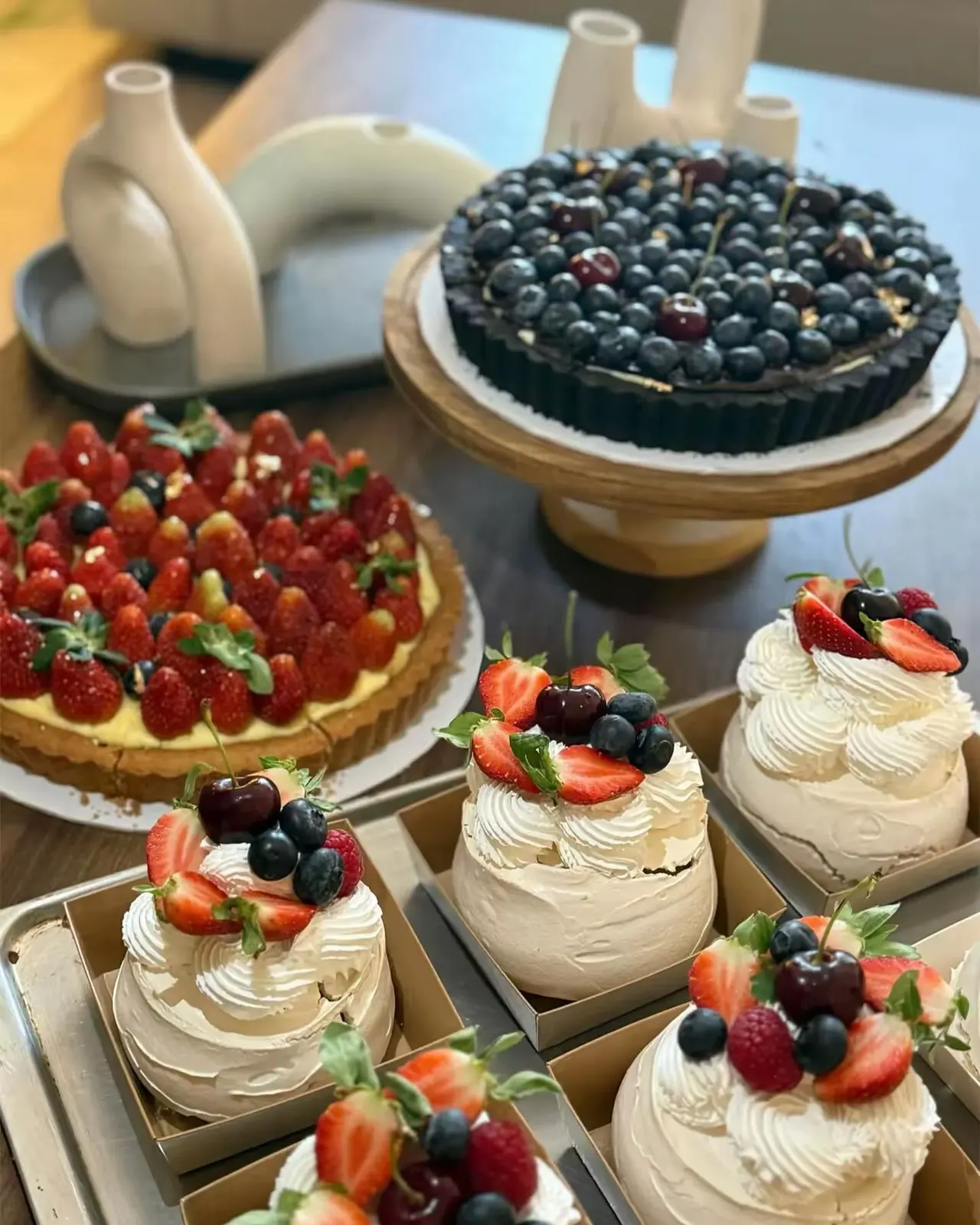 Strawberry and blueberry tarts with mini pavlovas